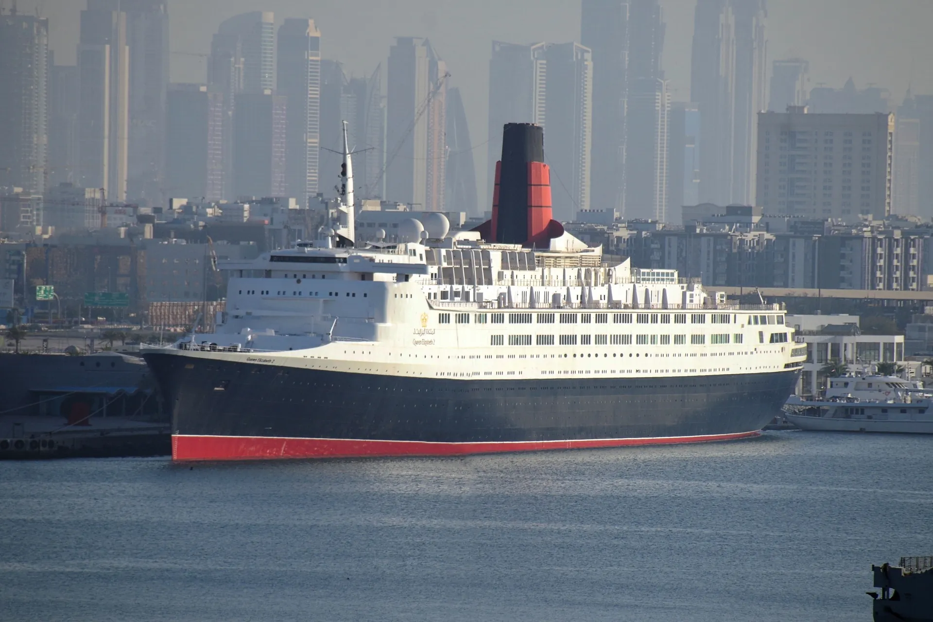 The QE2 moored at Mina Rashid, the city behind
